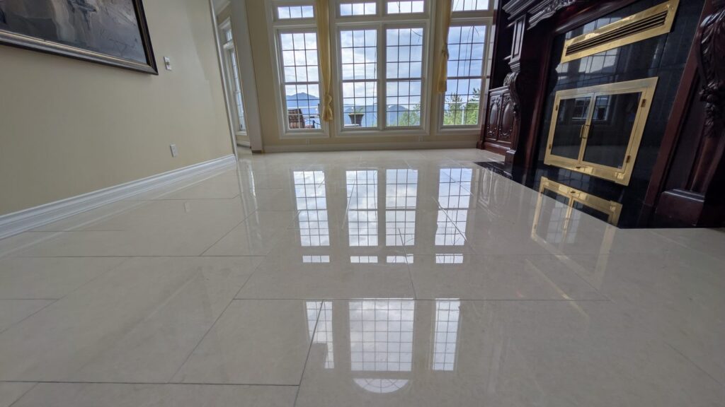 The same West Vancouver marble floor after honing and polishing, reflecting the windows