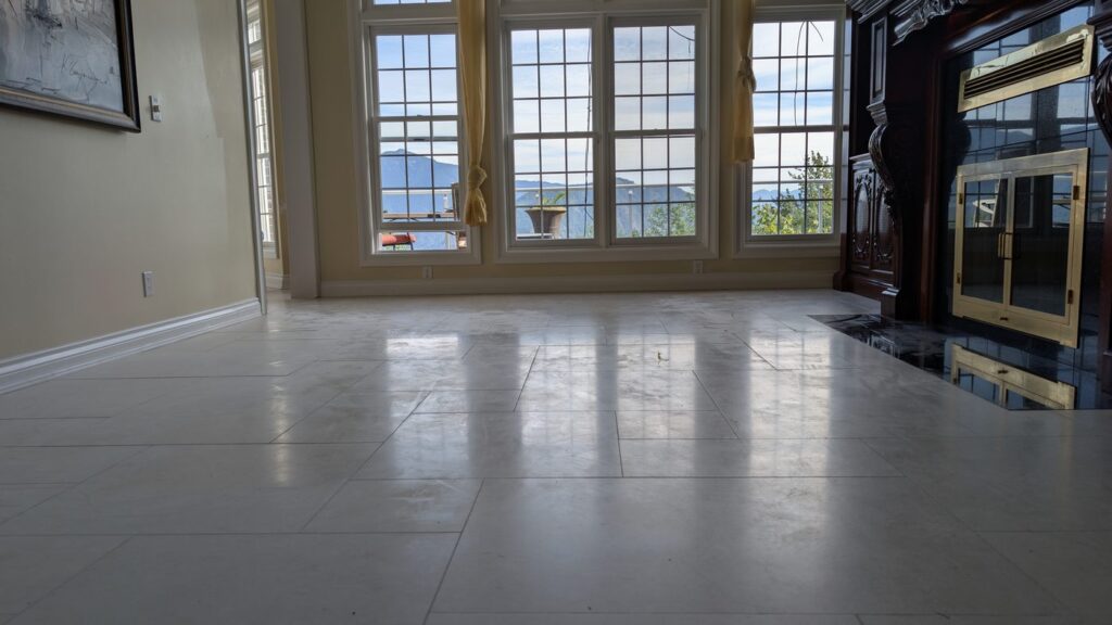 Marble floor in a West Vancouver home, worn flat and dull, before restoration