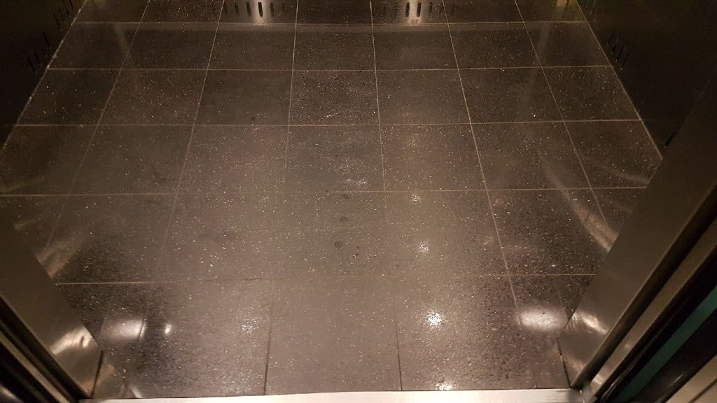 Black granite elevator floor, flat and dull with no reflection, before polishing