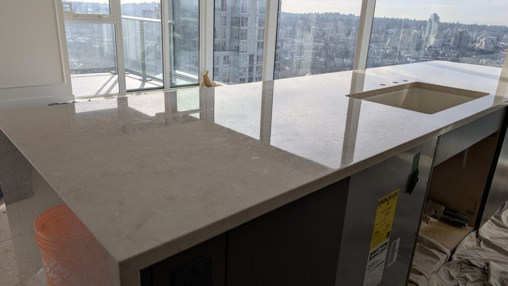 The same downtown Vancouver marble island after polishing, the surface reflecting the room
