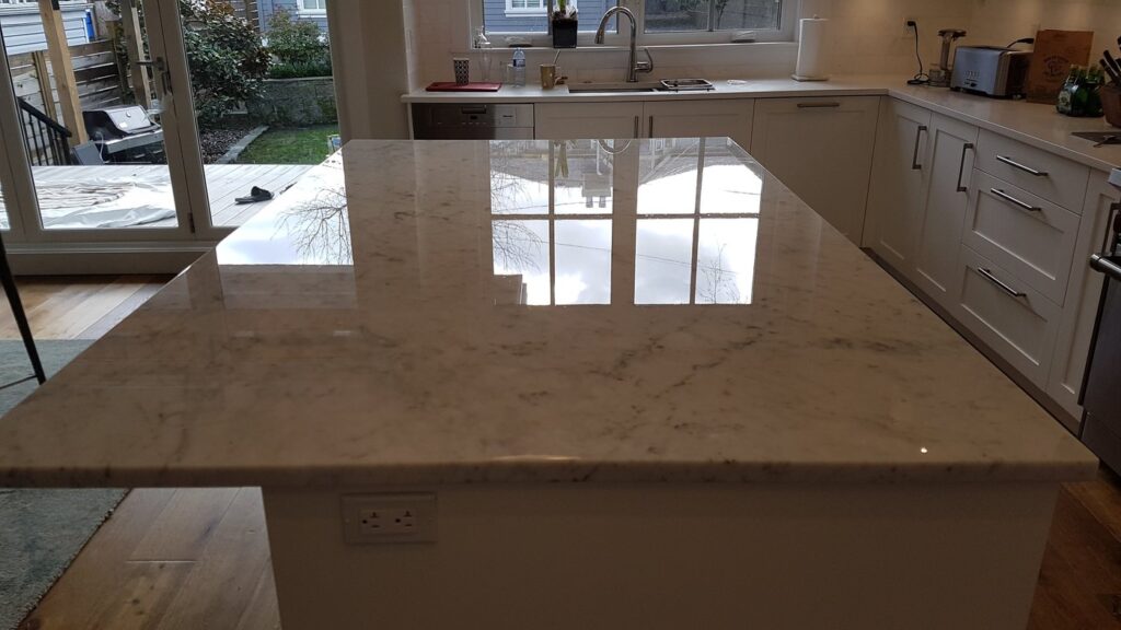 The same Richmond marble island after polishing, the window reflected in the top