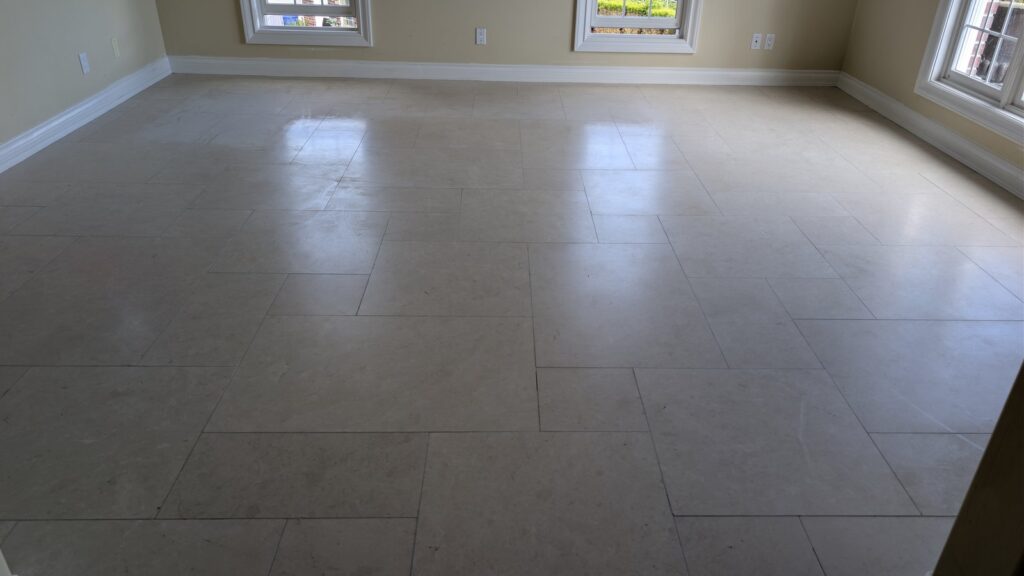 Cream marble floor in a West Vancouver home, flat and hazy with no reflection, before restoration
