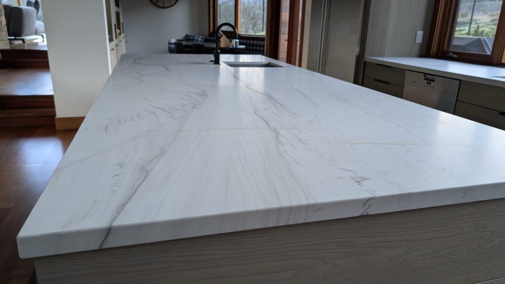 Quartzite kitchen island in a Whistler home finished honed, a soft matte surface with no reflection