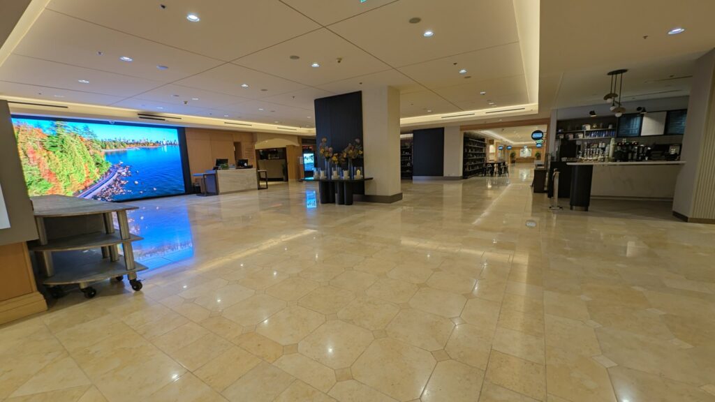 Polished stone lobby floor at the Westin Bayshore hotel in Vancouver, the ceiling lights reflected across it