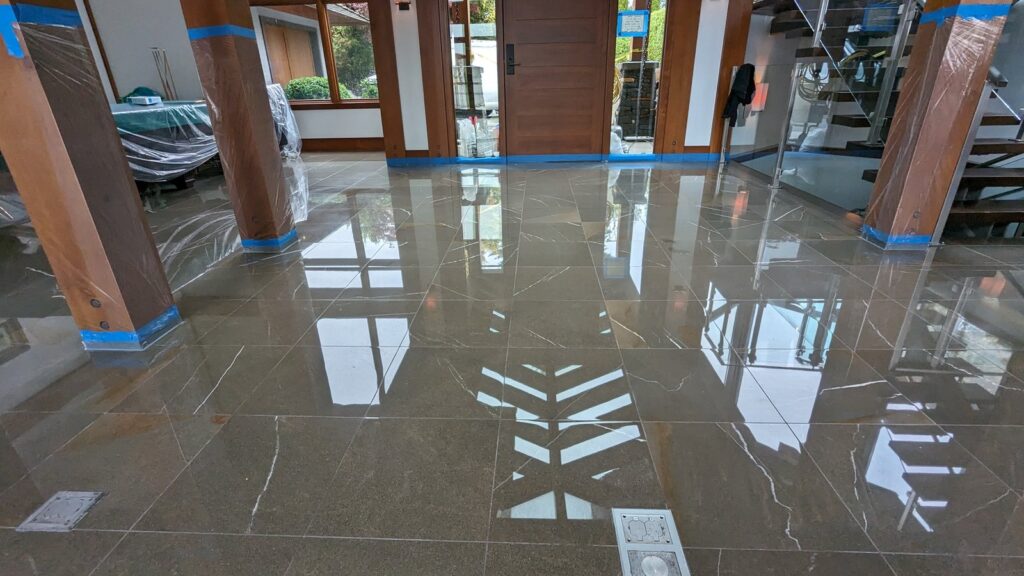 Polished marble floor with the wooden columns and doorways wrapped in plastic and tape for protection during restoration