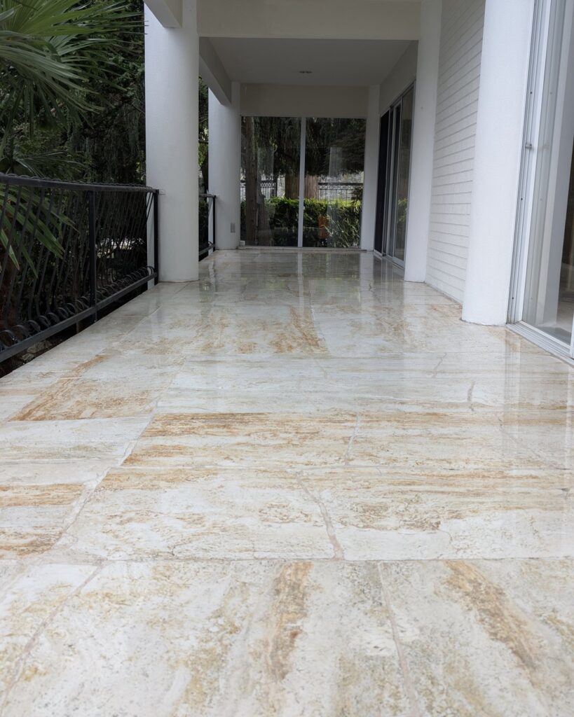 The same Point Grey travertine walkway after restoration, the surface polished and reflecting the columns